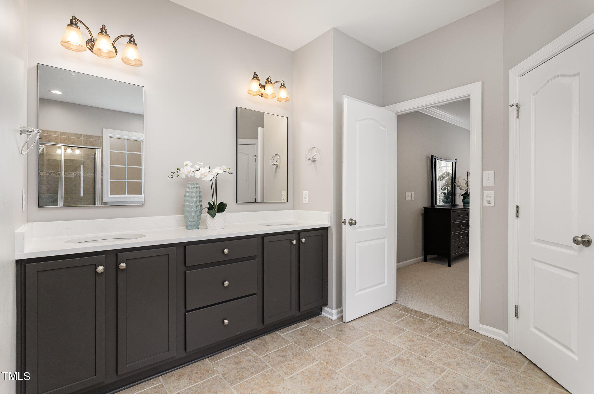10201 Darling Street Raleigh, NC 27613 - Photo 15 of 23 a bathroom with a double vanity sink and mirror