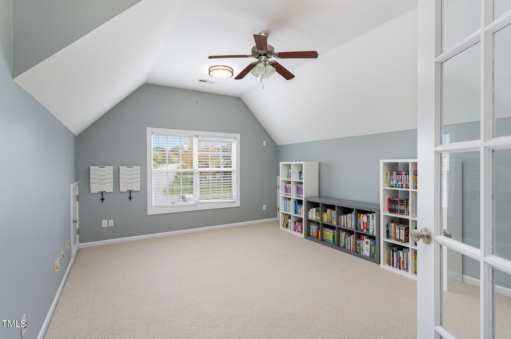 10201 Darling Street Raleigh, NC 27613 - Photo 20 of 23 a living room with lots of furniture and a book shelf