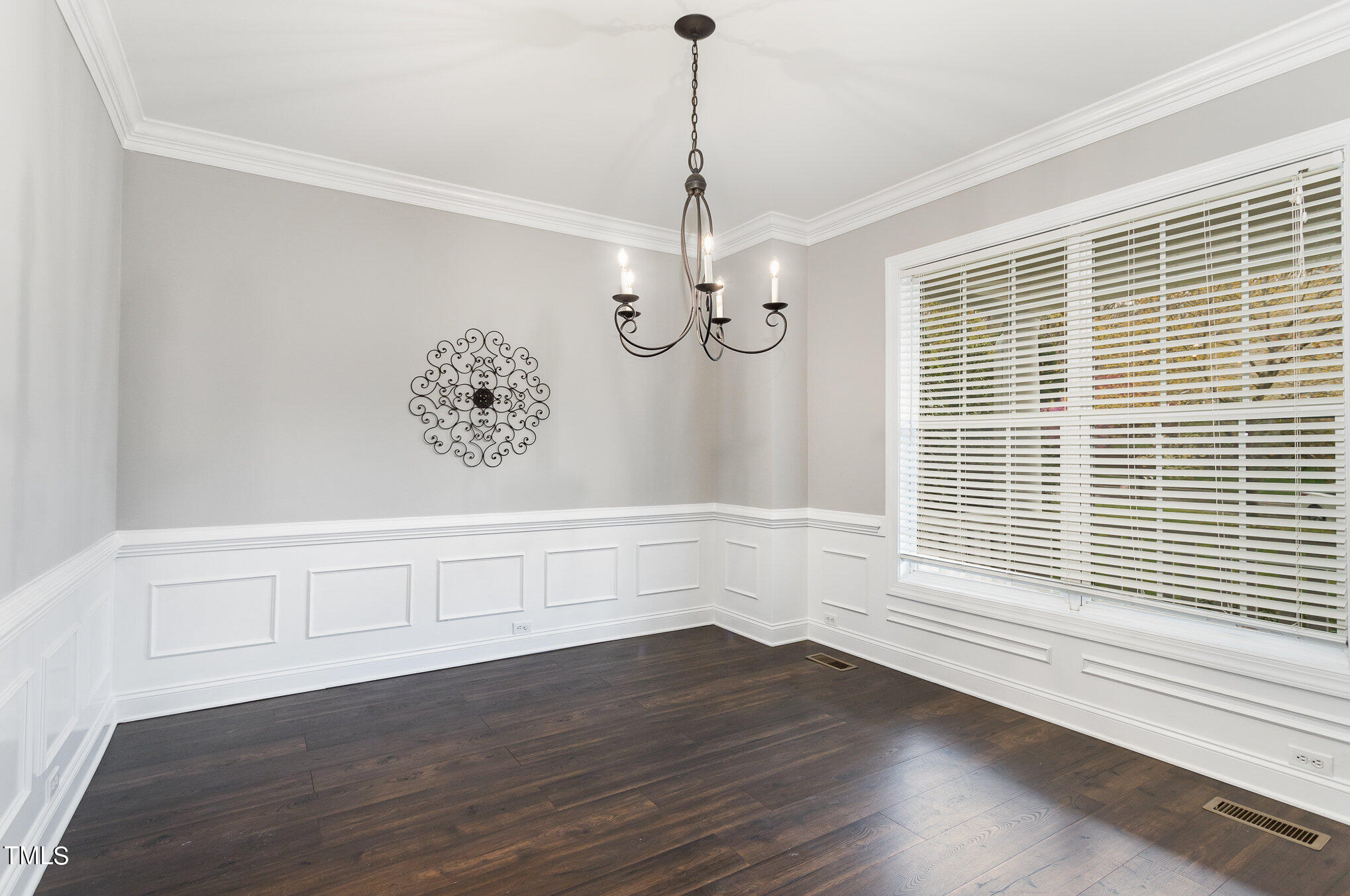 10201 Darling Street Raleigh, NC 27613 - Photo 3 of 23 a view of an empty room with a window and wooden floor