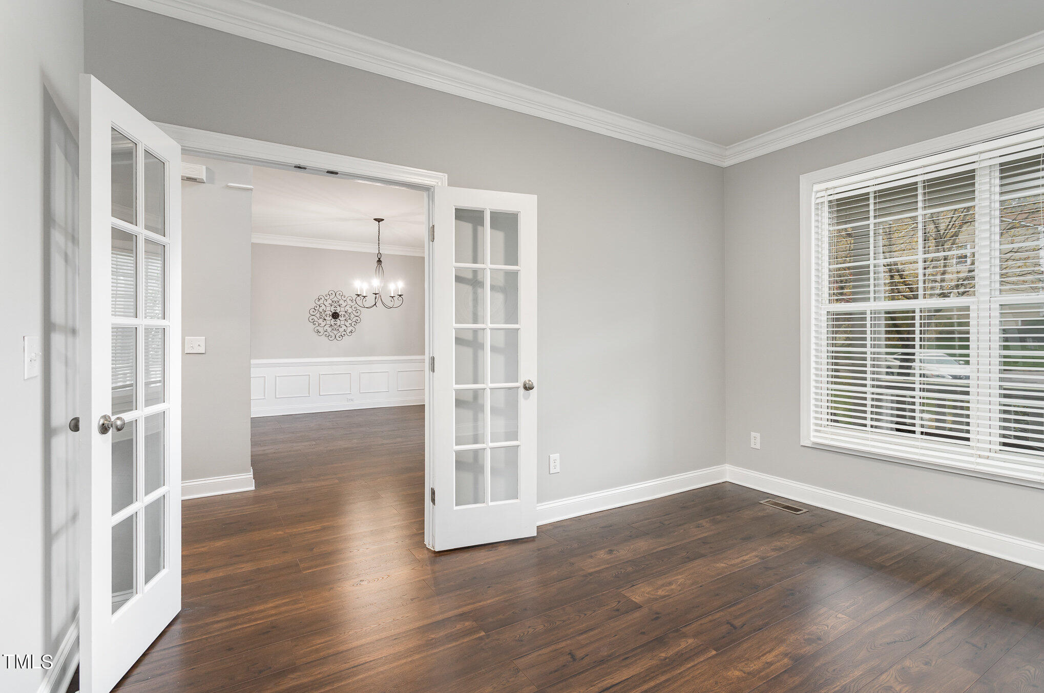 10201 Darling Street Raleigh, NC 27613 - Photo 4 of 23 a view of an empty room with wooden floor and a window