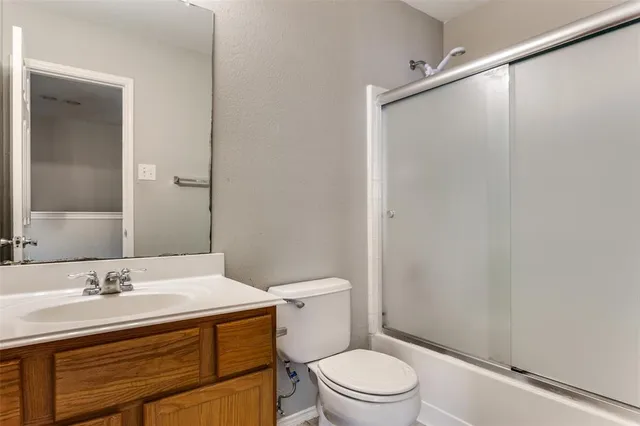 a bathroom with a sink a mirror and a toilet