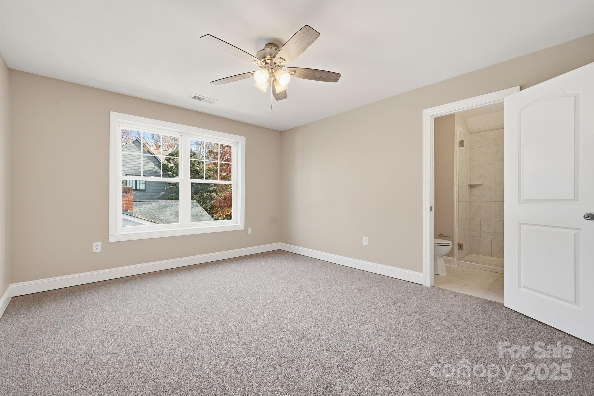101 McAlway Road Charlotte, NC 28211 - Photo 18 of 40 an empty room with windows and chandelier fan