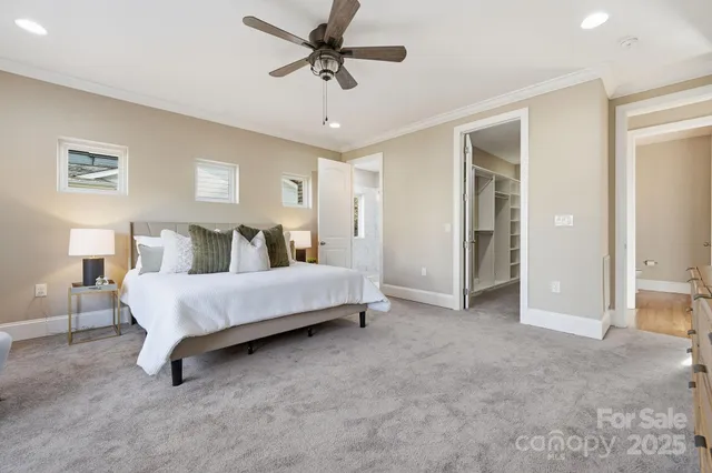 a spacious bedroom with a bed and a chandelier