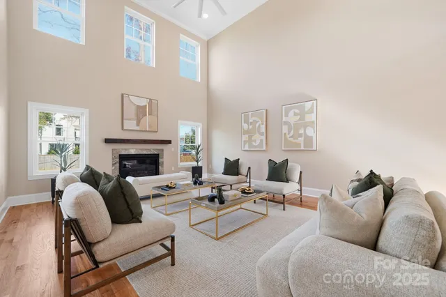 a living room with furniture fireplace and a window