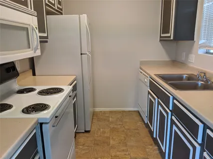 a kitchen that has a sink and a stove