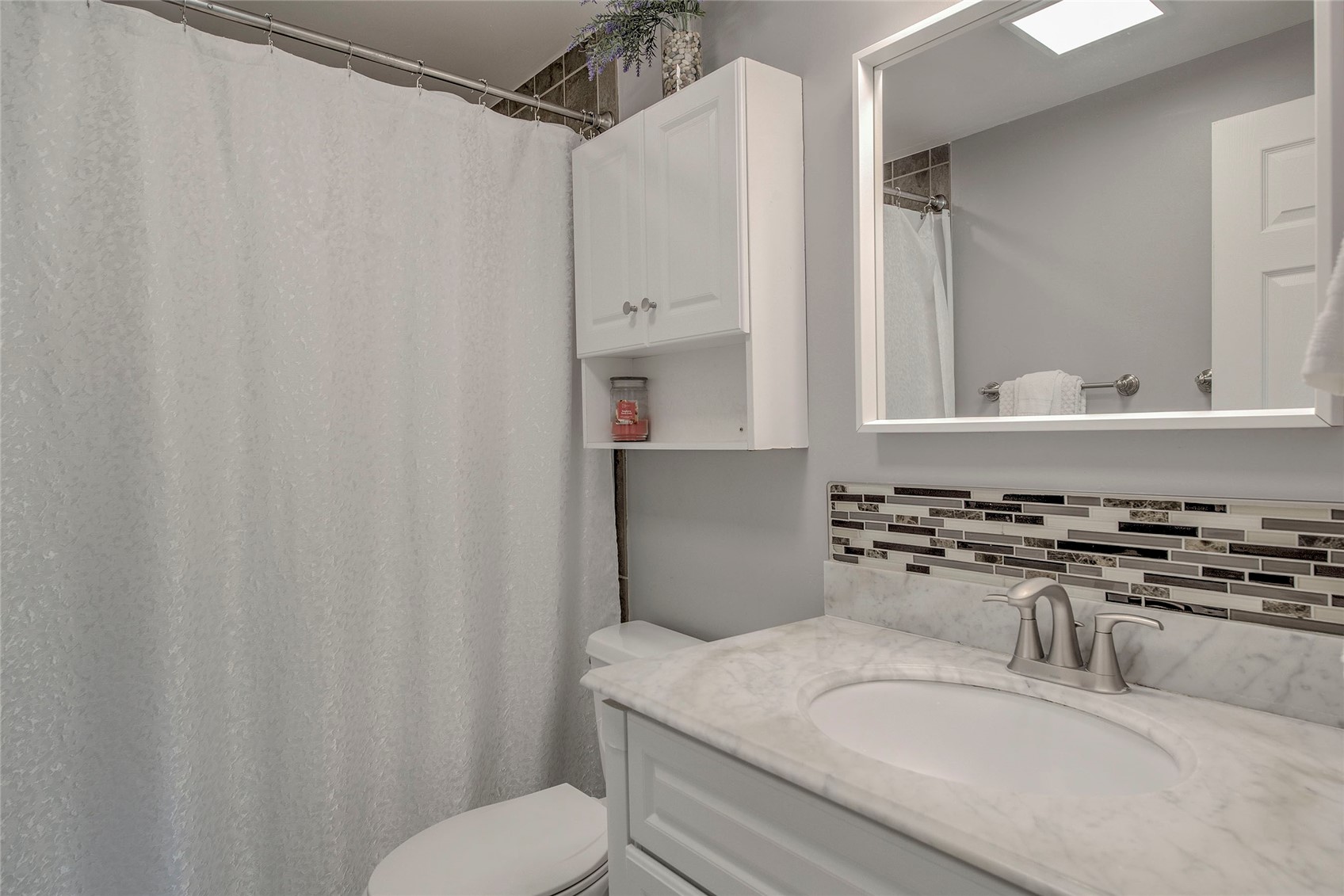 472 Ryan Gulch Road Silverthorne, CO 80498 - Photo 16 of 36 a bathroom with a granite countertop sink vanity mirror and toilet
