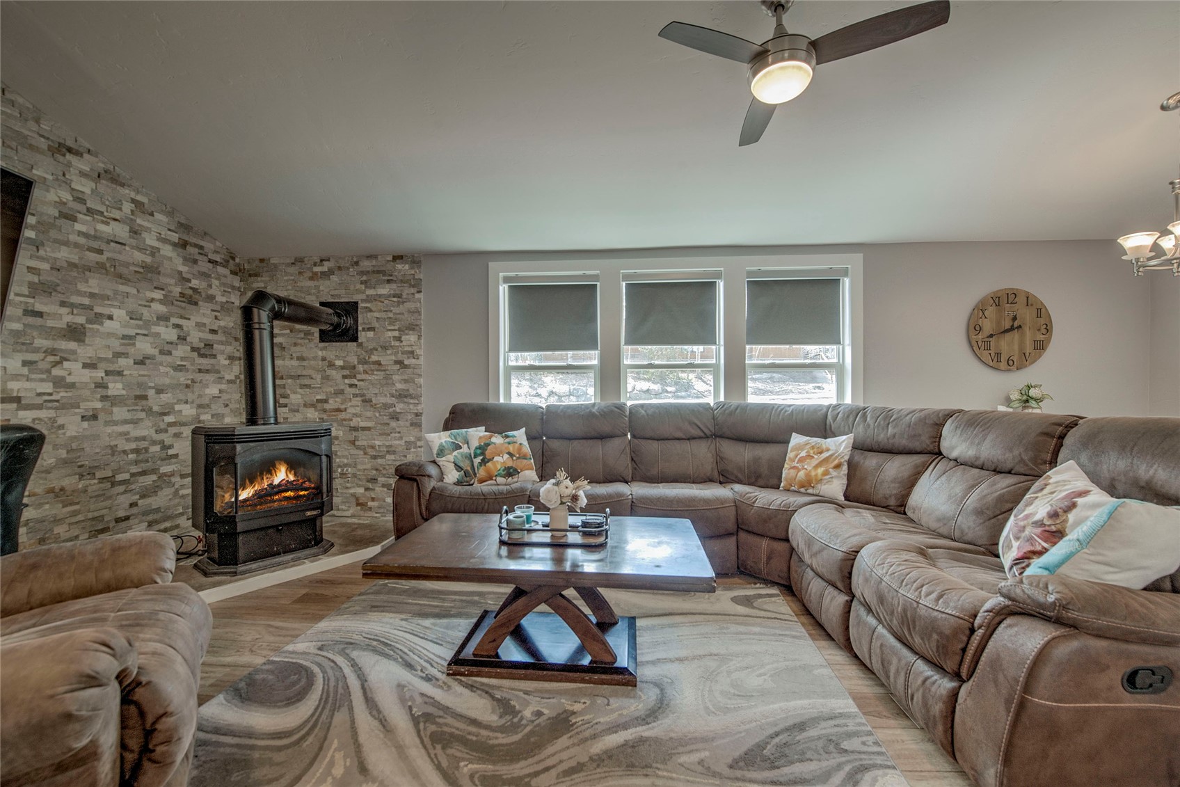 472 Ryan Gulch Road Silverthorne, CO 80498 - Photo 2 of 36 a living room with furniture a fireplace and a flat screen tv