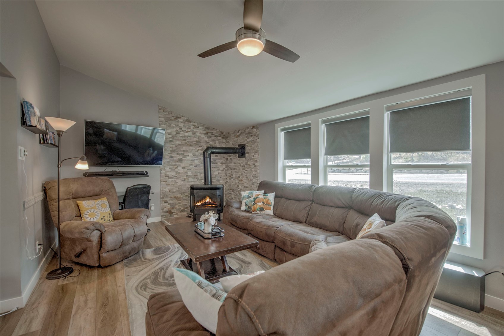 472 Ryan Gulch Road Silverthorne, CO 80498 - Photo 3 of 36 a living room with furniture a fireplace and a flat screen tv