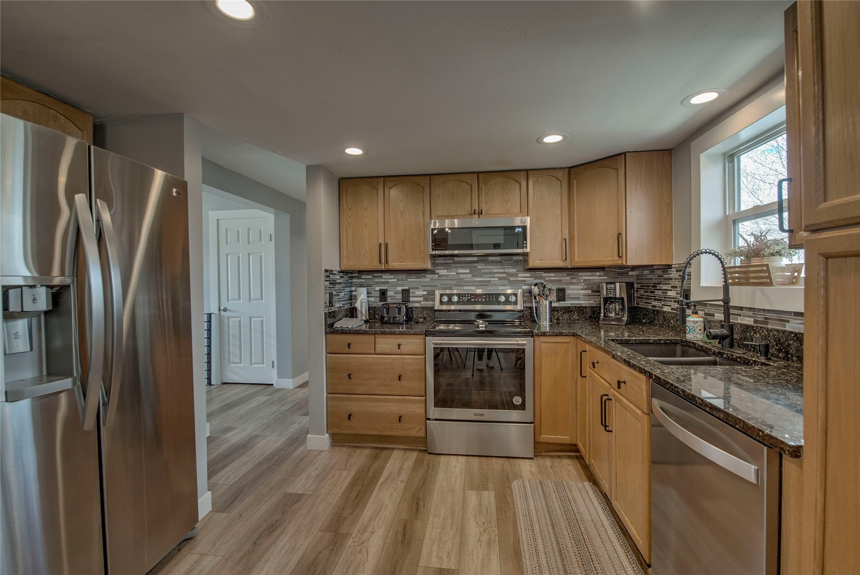 472 Ryan Gulch Road Silverthorne, CO 80498 - Photo 7 of 36 a kitchen with kitchen island granite countertop stainless steel appliances stove refrigerator and cabinets