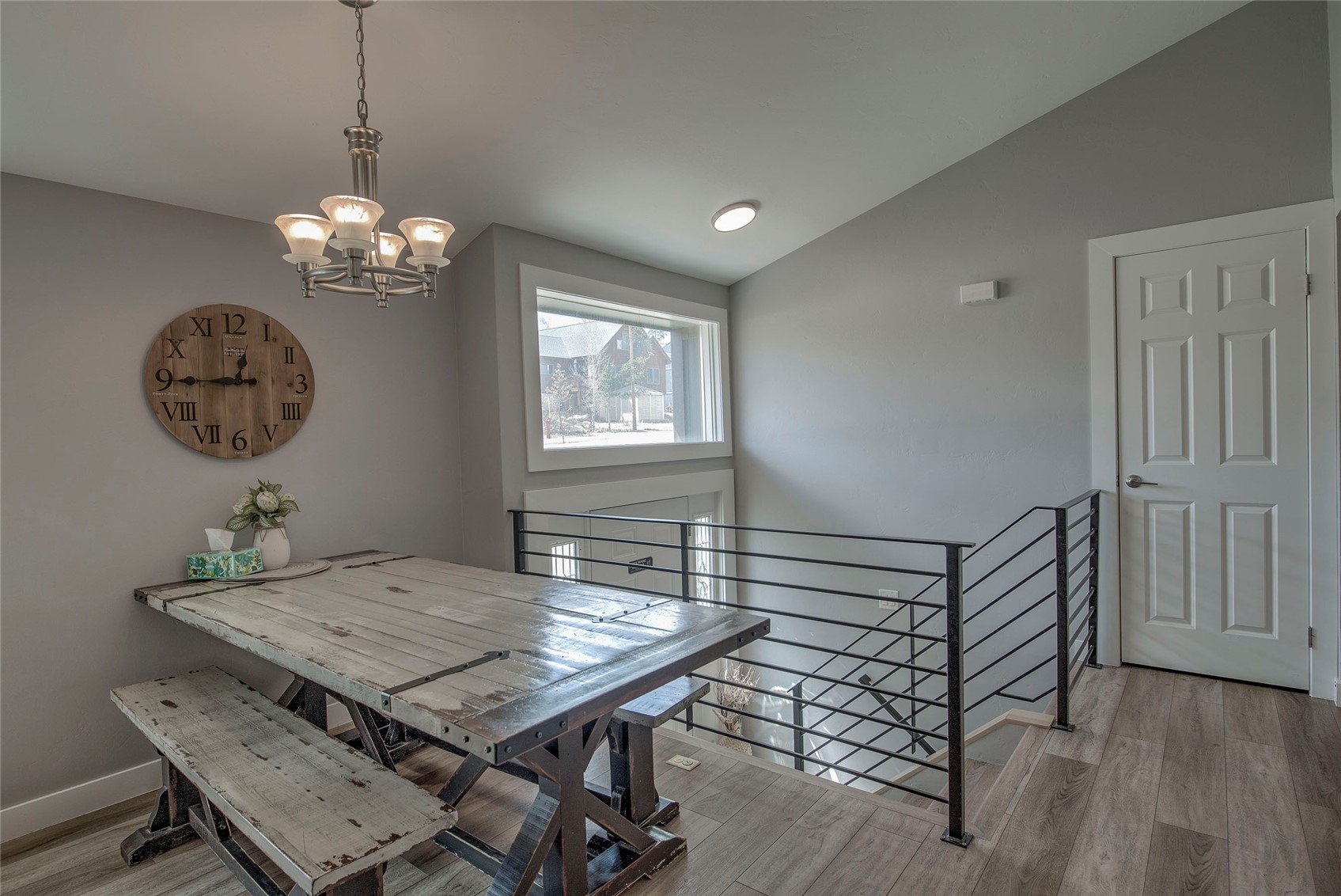 472 Ryan Gulch Road Silverthorne, CO 80498 - Photo 9 of 36 a view of a dining room with furniture wooden floor and chandelier