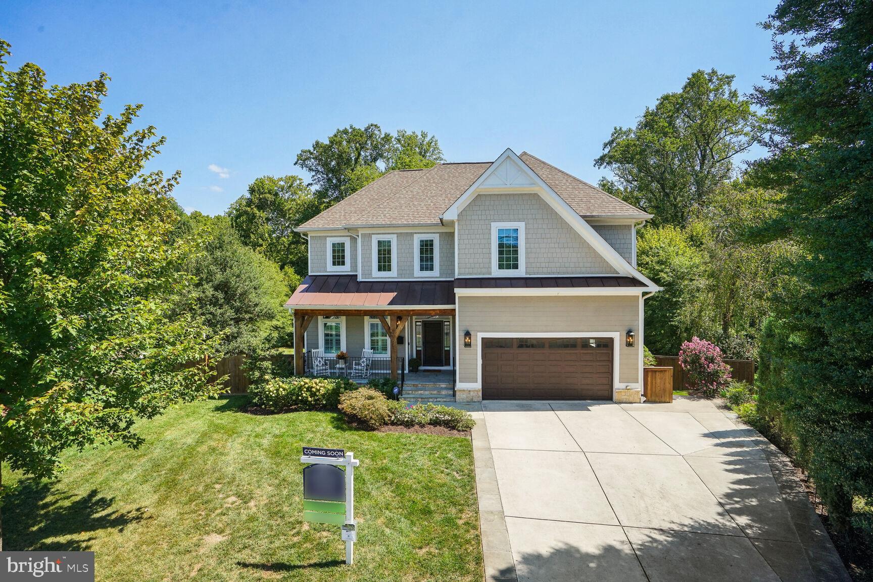 6701 Lumsden Street McLean, VA 22101 - Photo 3 of 57 a front view of a house with a yard and garage