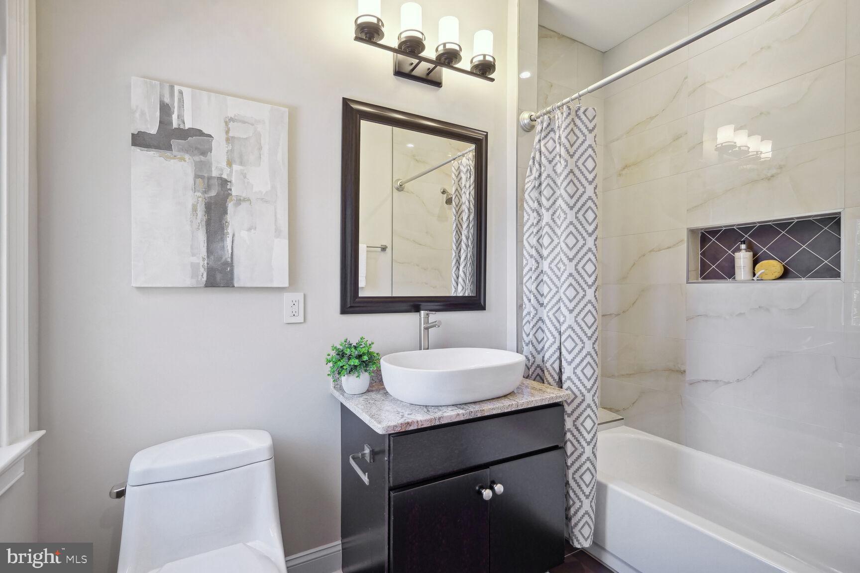 6701 Lumsden Street McLean, VA 22101 - Photo 30 of 57 a bathroom with a bathtub sink vanity mirror and toilet