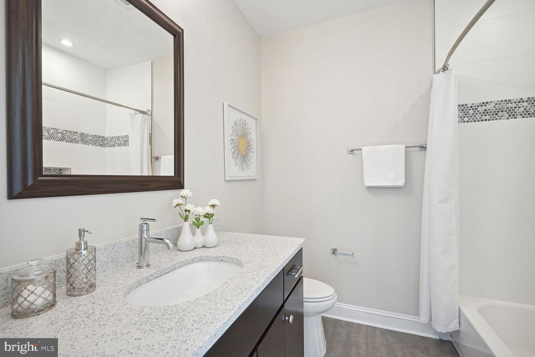 6701 Lumsden Street McLean, VA 22101 - Photo 34 of 57 a bathroom with a granite countertop sink a toilet and a mirror