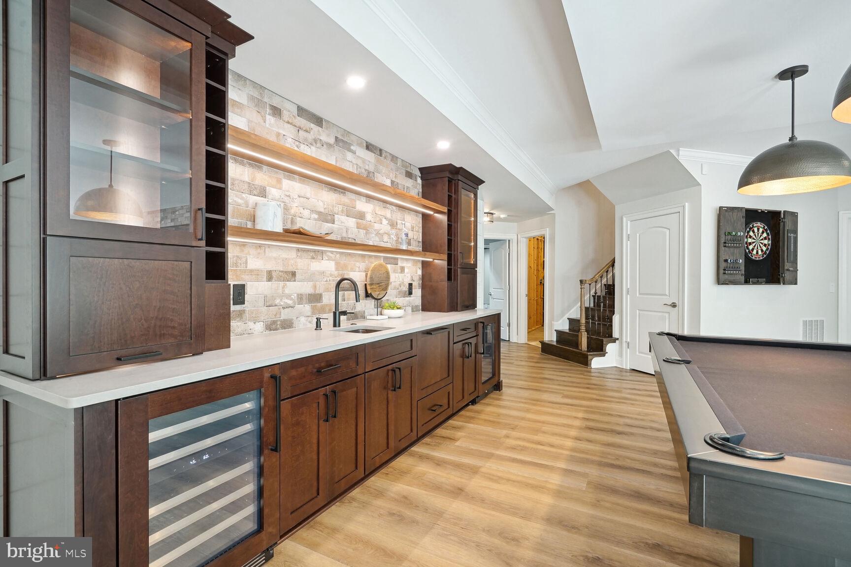 6701 Lumsden Street McLean, VA 22101 - Photo 36 of 57 a large kitchen with stainless steel appliances granite countertop a sink and dishwasher a stove with wooden floors