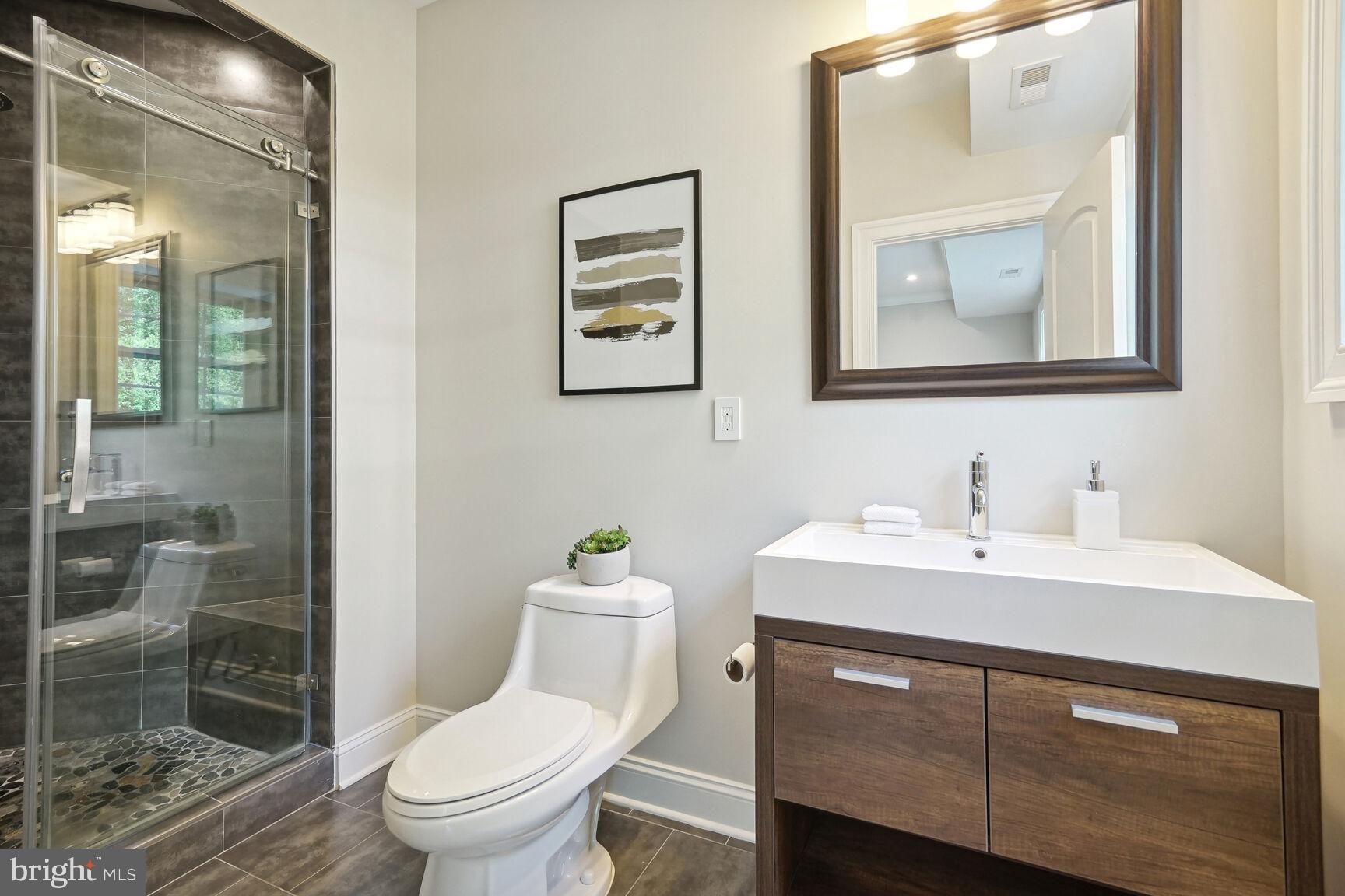 6701 Lumsden Street McLean, VA 22101 - Photo 46 of 57 a bathroom with a toilet a sink and mirror