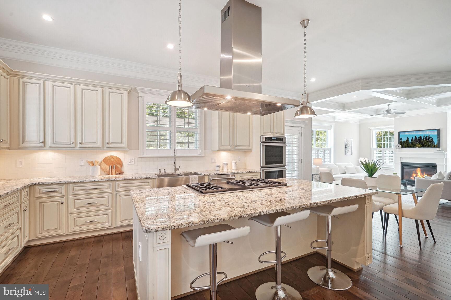 6701 Lumsden Street McLean, VA 22101 - Photo 9 of 57 a kitchen with granite countertop a sink a center island cabinets and wooden floor