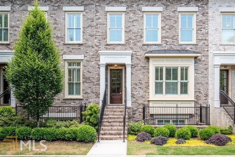 1303 Riverscall, Unit 69 Atlanta, GA 30339 - Photo 1 of 1 a front view of a house with a yard and plants