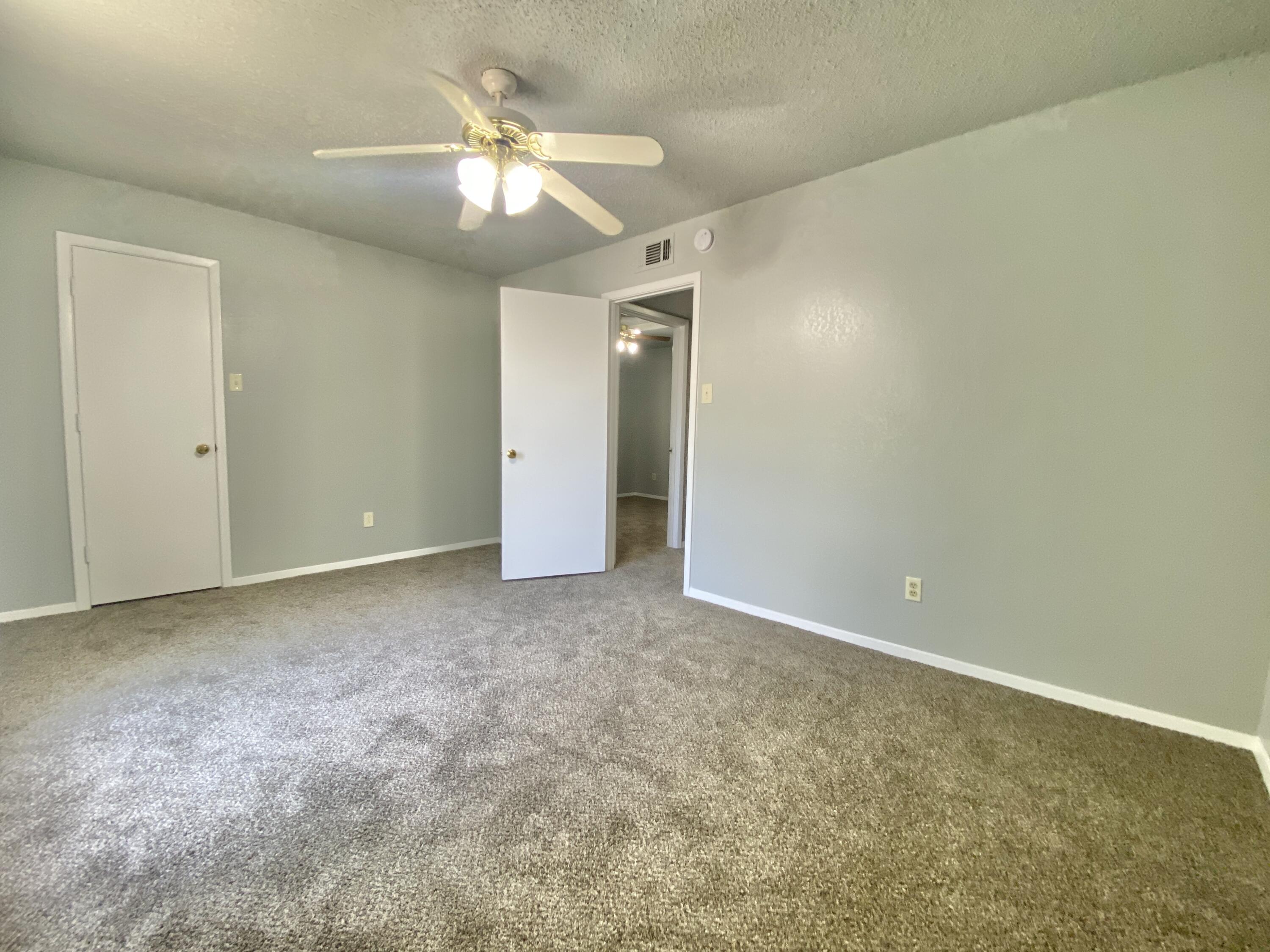 4707 48th Street Lubbock, TX 79414 - Photo 16 of 18 an empty room with a chandelier fan and closet