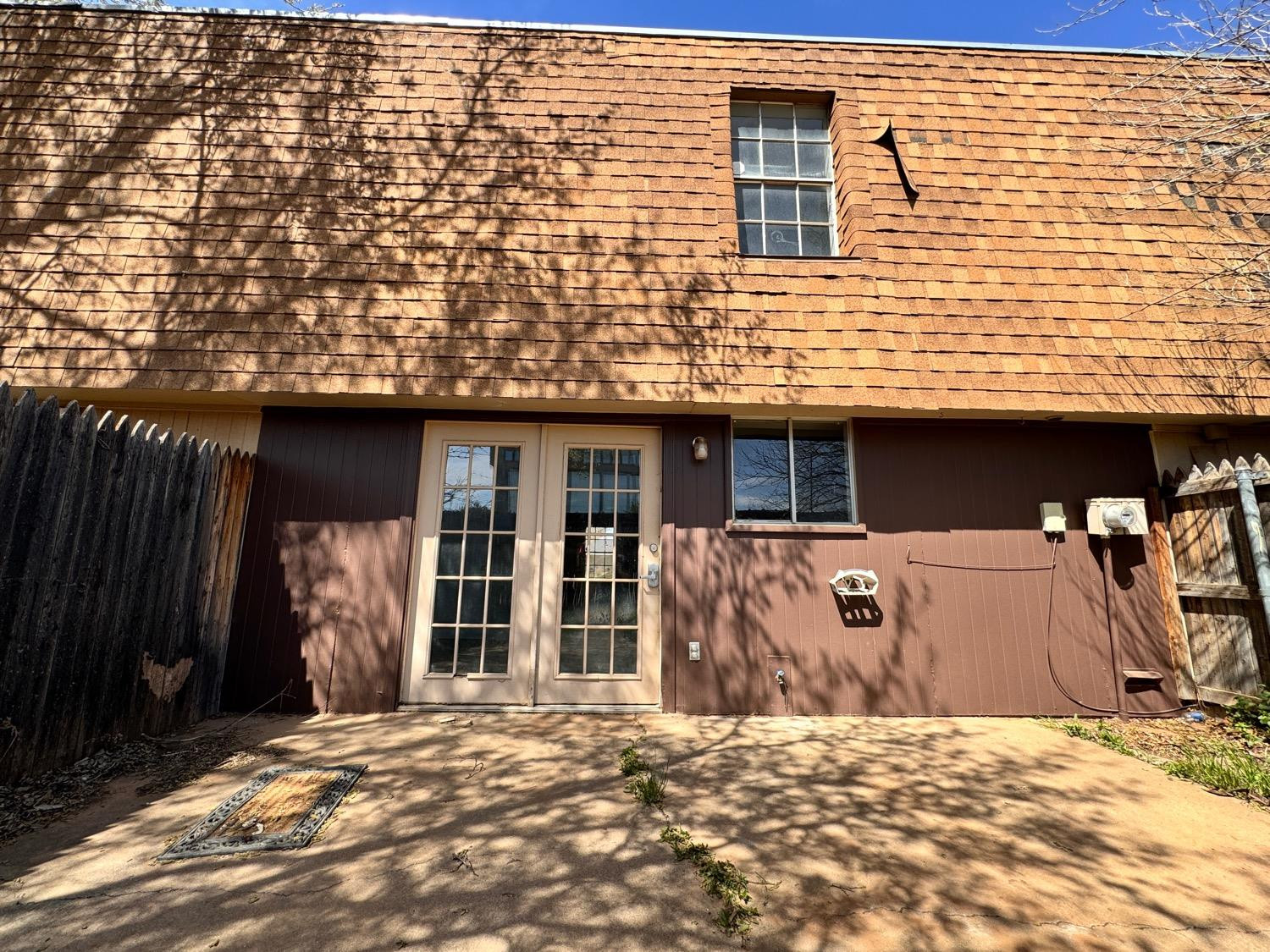 4707 48th Street Lubbock, TX 79414 - Photo 17 of 18 a view of a house with a door and wooden walls
