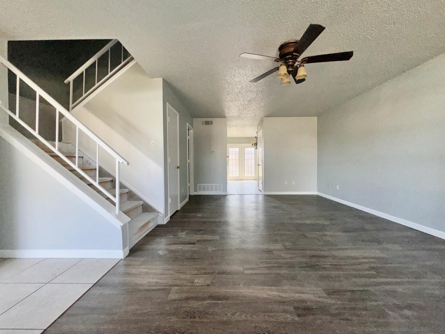 4707 48th Street Lubbock, TX 79414 - Photo 9 of 18 a view of a hallway with the wooden floor and staircase