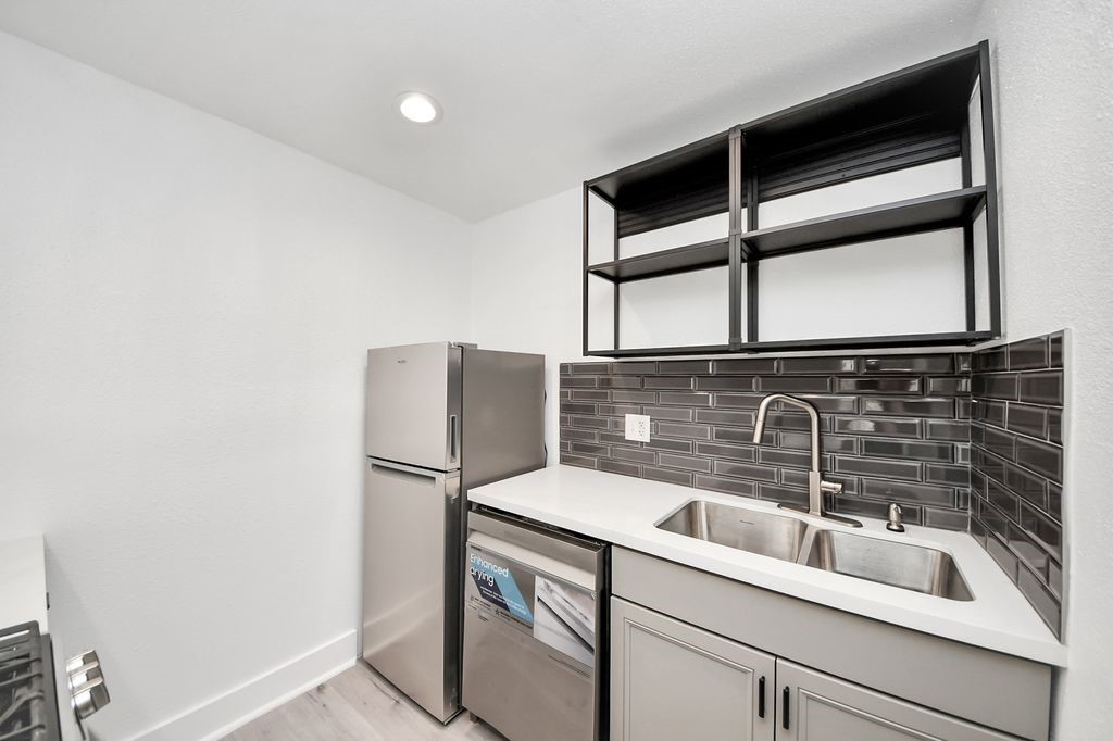 1014 Graham Drive Tomball, TX 77375 - Photo 13 of 37 a close view of a sink and a refrigerator