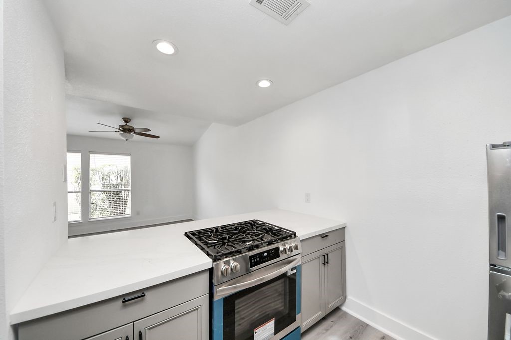 1014 Graham Drive Tomball, TX 77375 - Photo 14 of 37 a kitchen with a stove cabinets and window