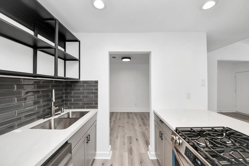 1014 Graham Drive Tomball, TX 77375 - Photo 15 of 37 a kitchen with a sink and a stove top oven
