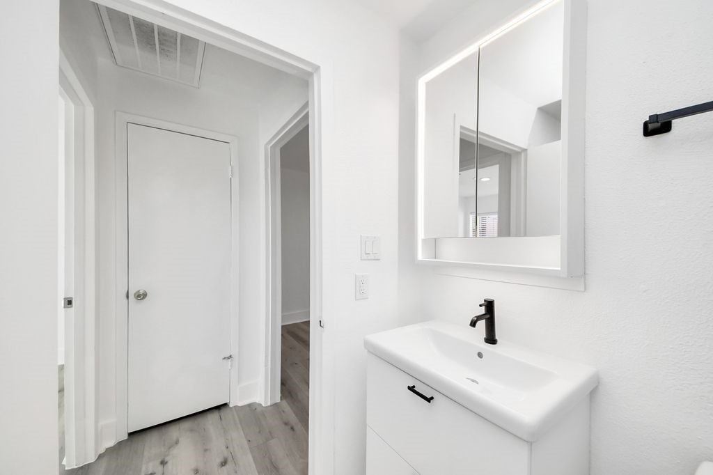 1014 Graham Drive Tomball, TX 77375 - Photo 19 of 37 a bathroom with a sink and a mirror