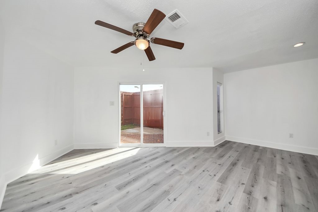 1014 Graham Drive Tomball, TX 77375 - Photo 24 of 37 an empty room with wooden floor and windows