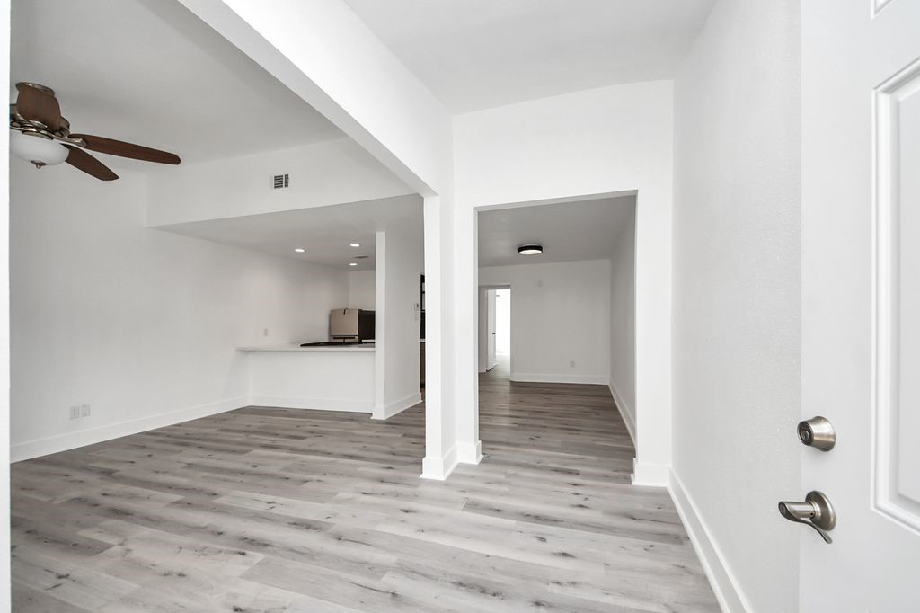1014 Graham Drive Tomball, TX 77375 - Photo 4 of 37 a view of a hallway with wooden floor and a bathroom