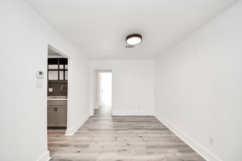 1014 Graham Drive Tomball, TX 77375 - Photo 6 of 37 a view of a kitchen with wooden floor and cabinets