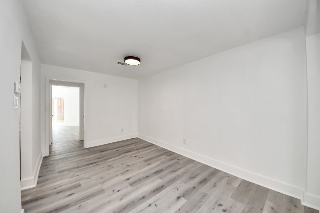 1014 Graham Drive Tomball, TX 77375 - Photo 7 of 37 a view of an empty room with wooden floor and a window