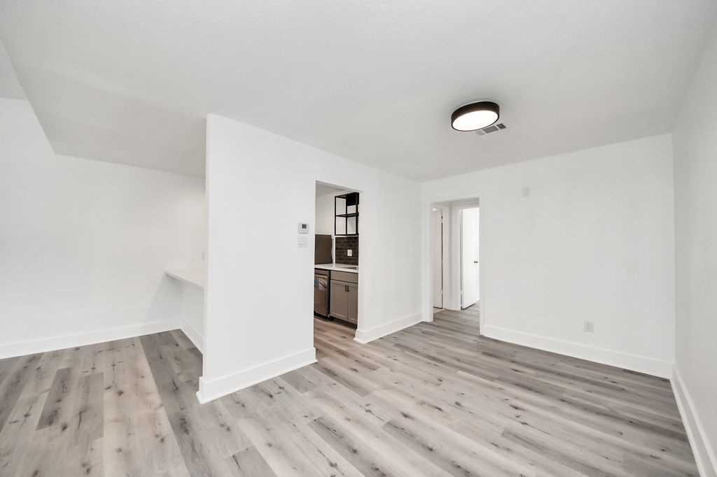 1014 Graham Drive Tomball, TX 77375 - Photo 9 of 37 an empty room with wooden floor and entrance