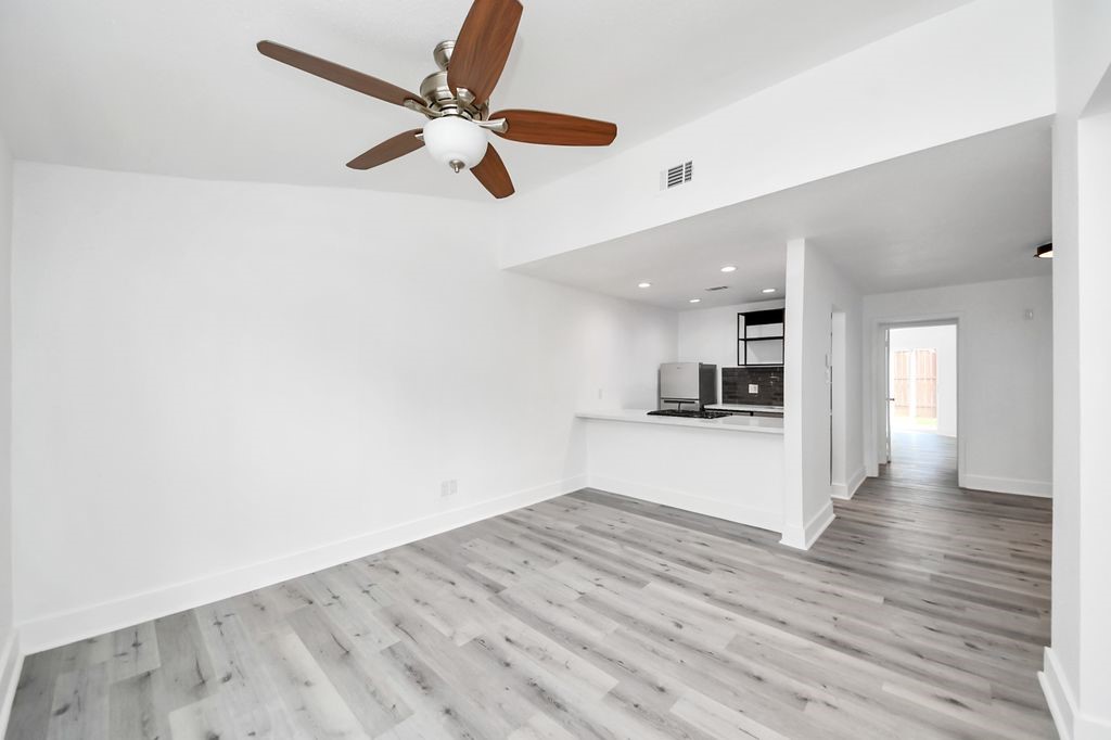 1014 Graham Drive Tomball, TX 77375 - Photo 10 of 37 a view of a kitchen with a sink and dishwasher a refrigerator with wooden floor