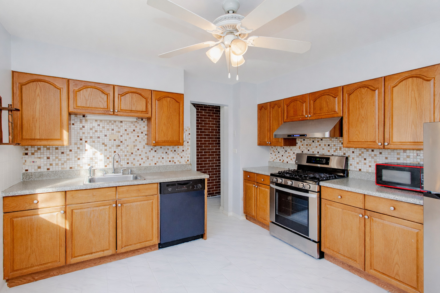 612 Maple Court, Unit 612 Mount Prospect, IL 60056 - Photo 4 of 12 a kitchen with stainless steel appliances granite countertop a stove a sink and a refrigerator