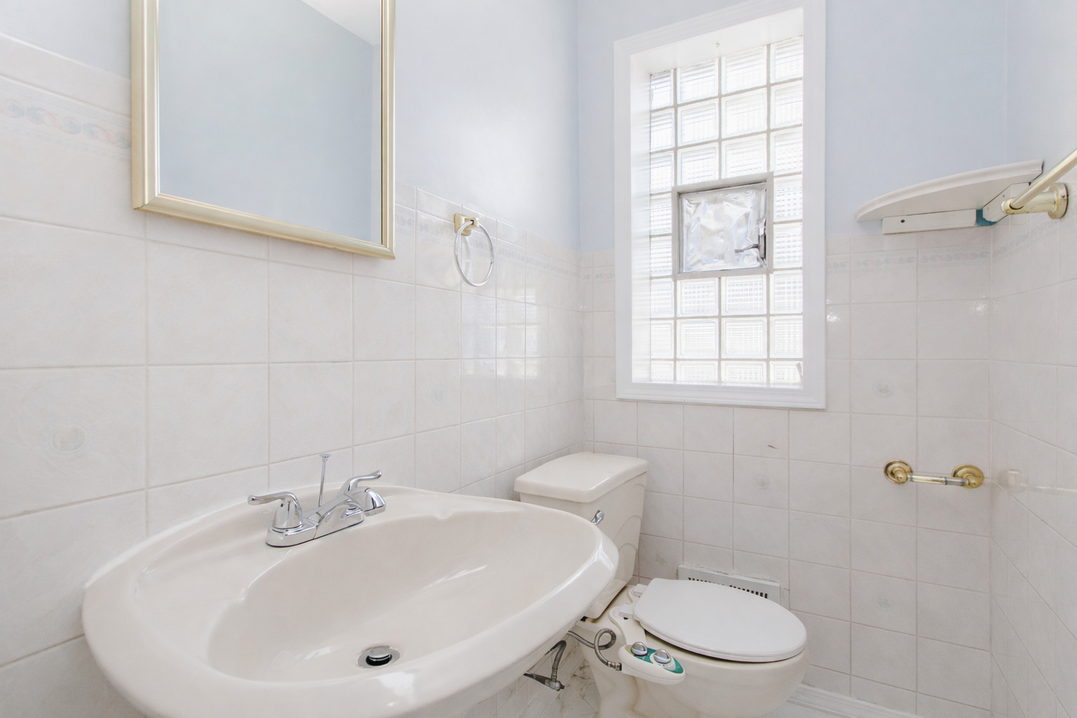 612 Maple Court, Unit 612 Mount Prospect, IL 60056 - Photo 5 of 12 a bathroom with a sink a toilet and a window
