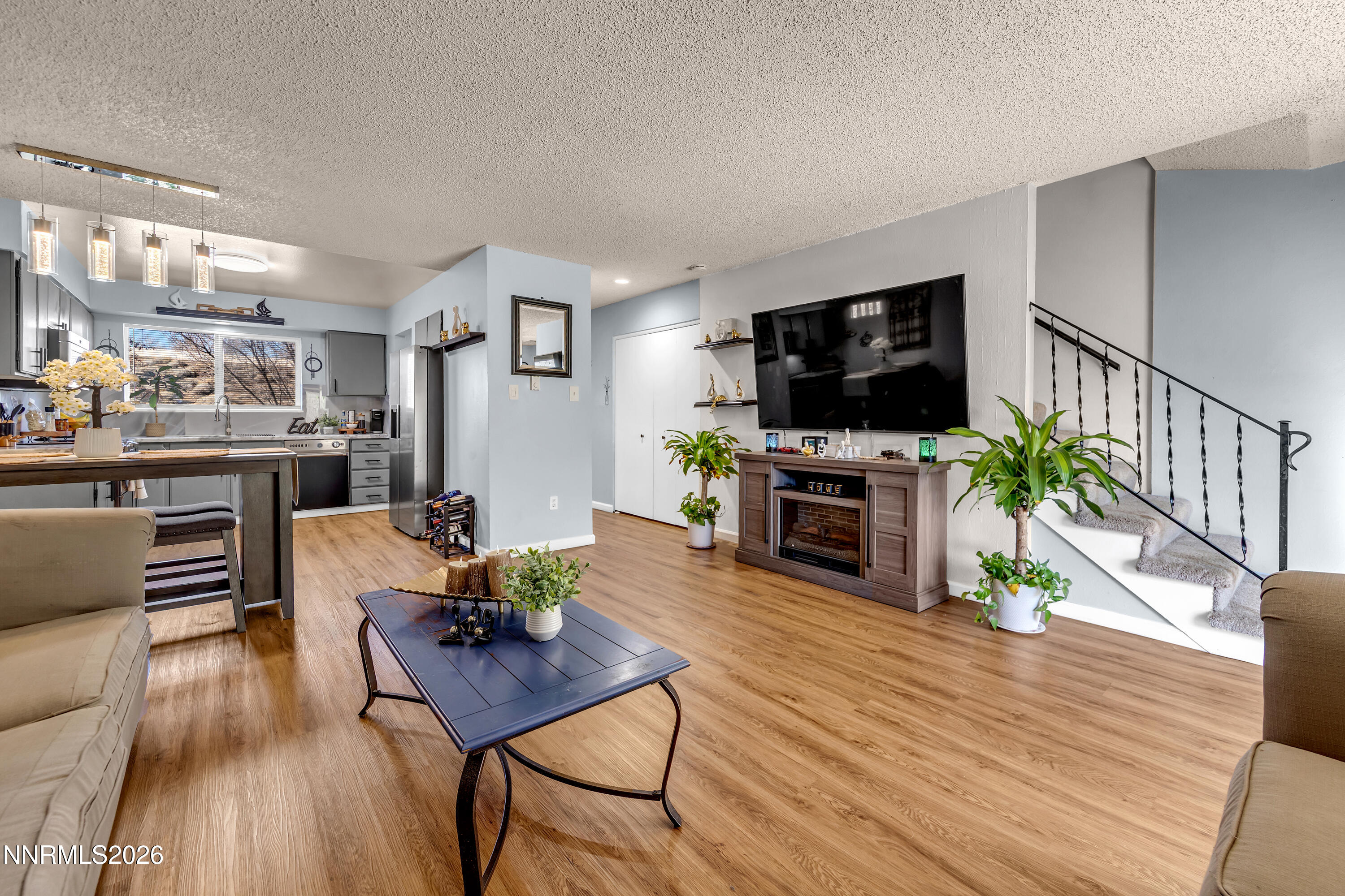 562 Smithridge Park Reno, NV 89502 - Photo 14 of 43 a living room with furniture a flat screen tv and a fireplace