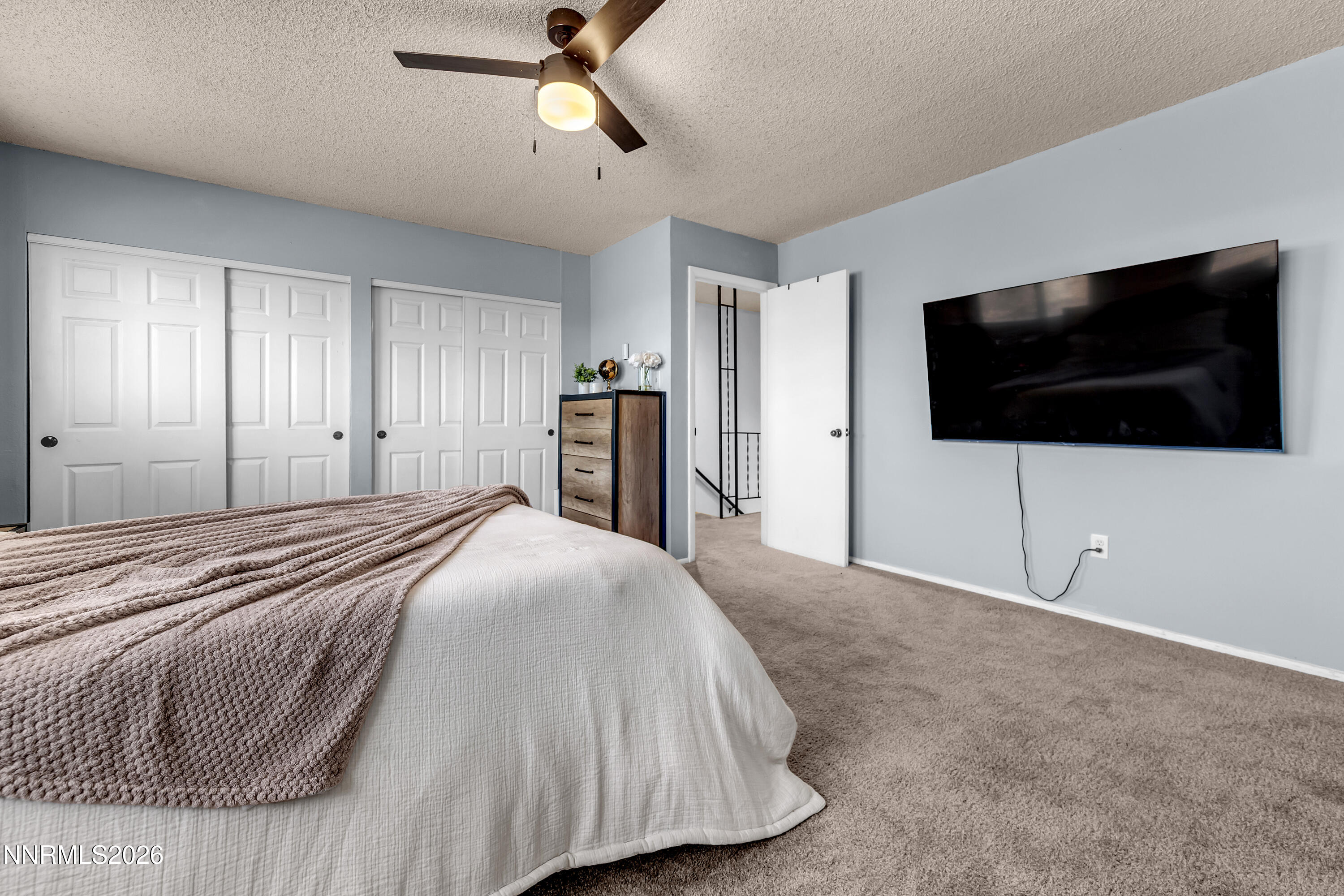 562 Smithridge Park Reno, NV 89502 - Photo 24 of 43 a spacious bedroom with a bed and a flat screen tv