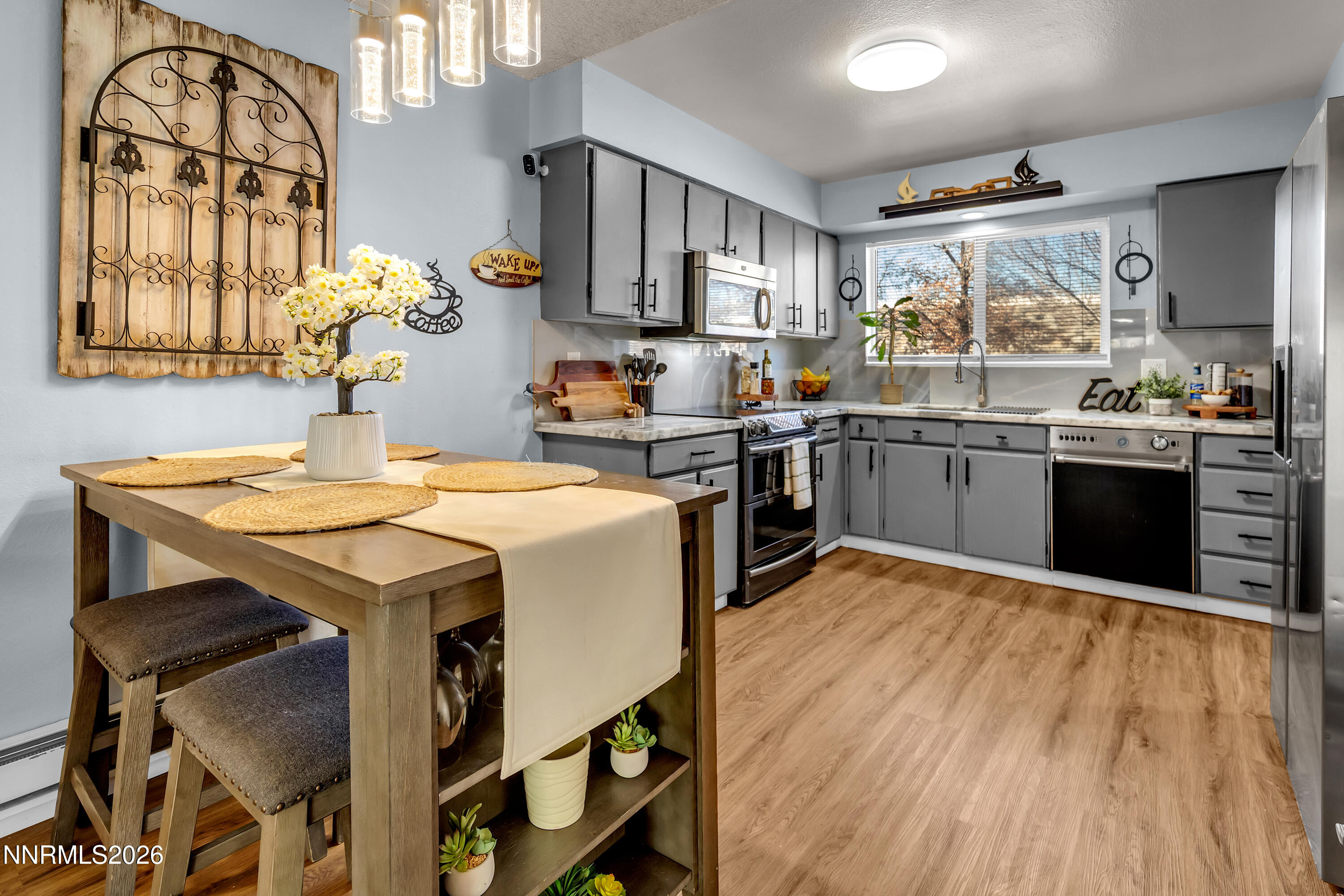 562 Smithridge Park Reno, NV 89502 - Photo 3 of 43 a kitchen with a table chairs stove and cabinets