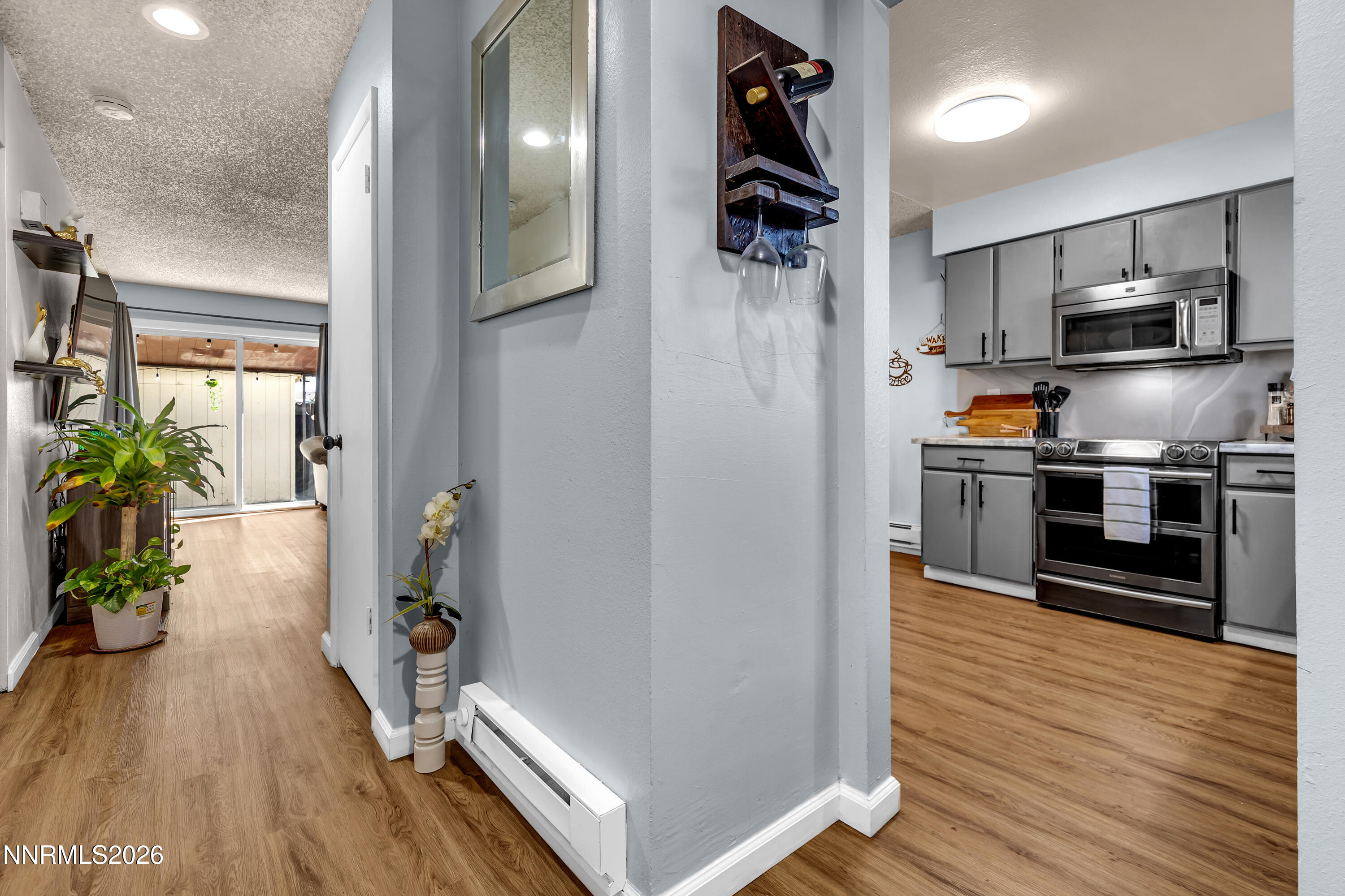 562 Smithridge Park Reno, NV 89502 - Photo 4 of 43 a kitchen with stainless steel appliances a refrigerator and wooden floor