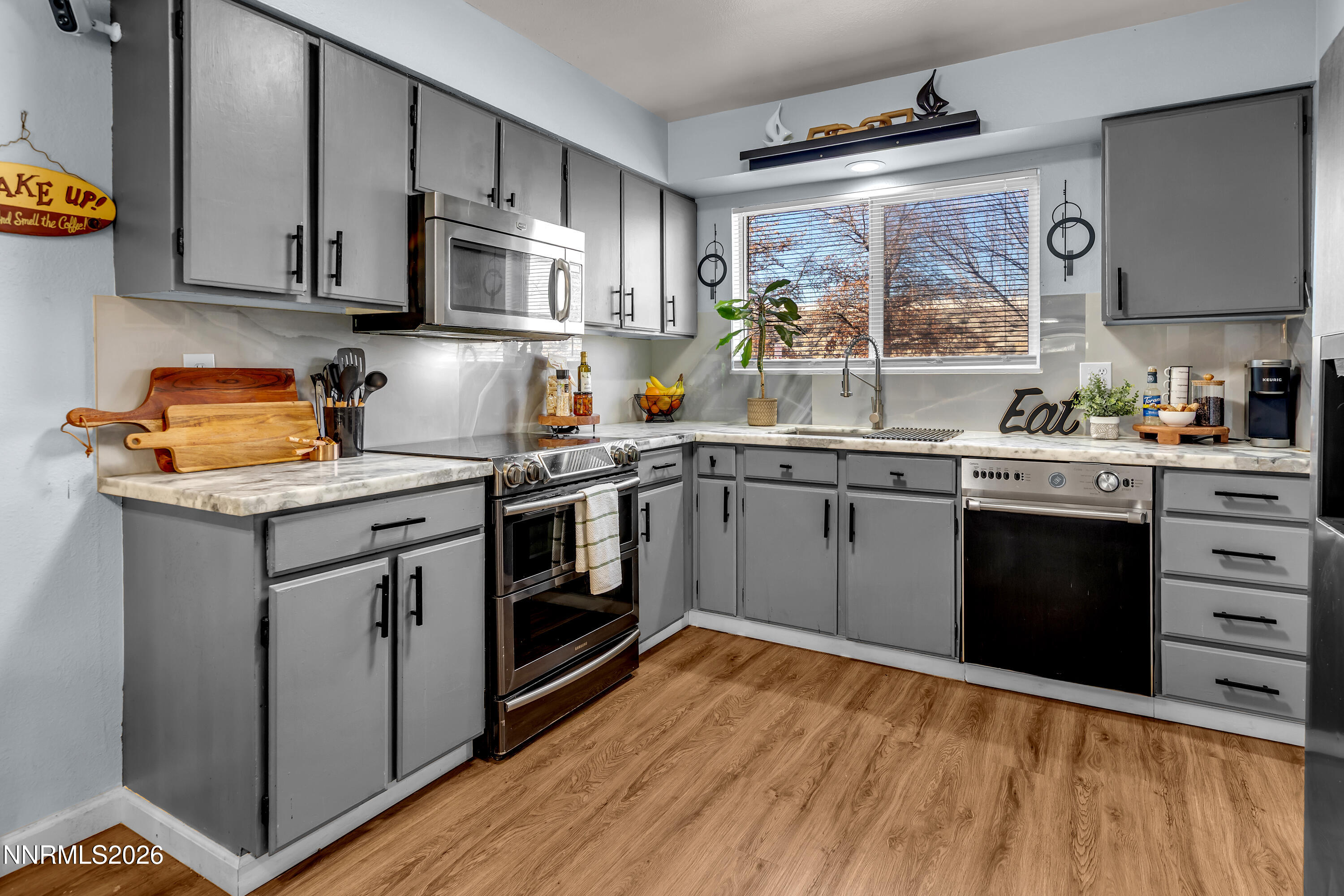 562 Smithridge Park Reno, NV 89502 - Photo 5 of 43 a kitchen with stainless steel appliances granite countertop a stove a sink dishwasher and a refrigerator