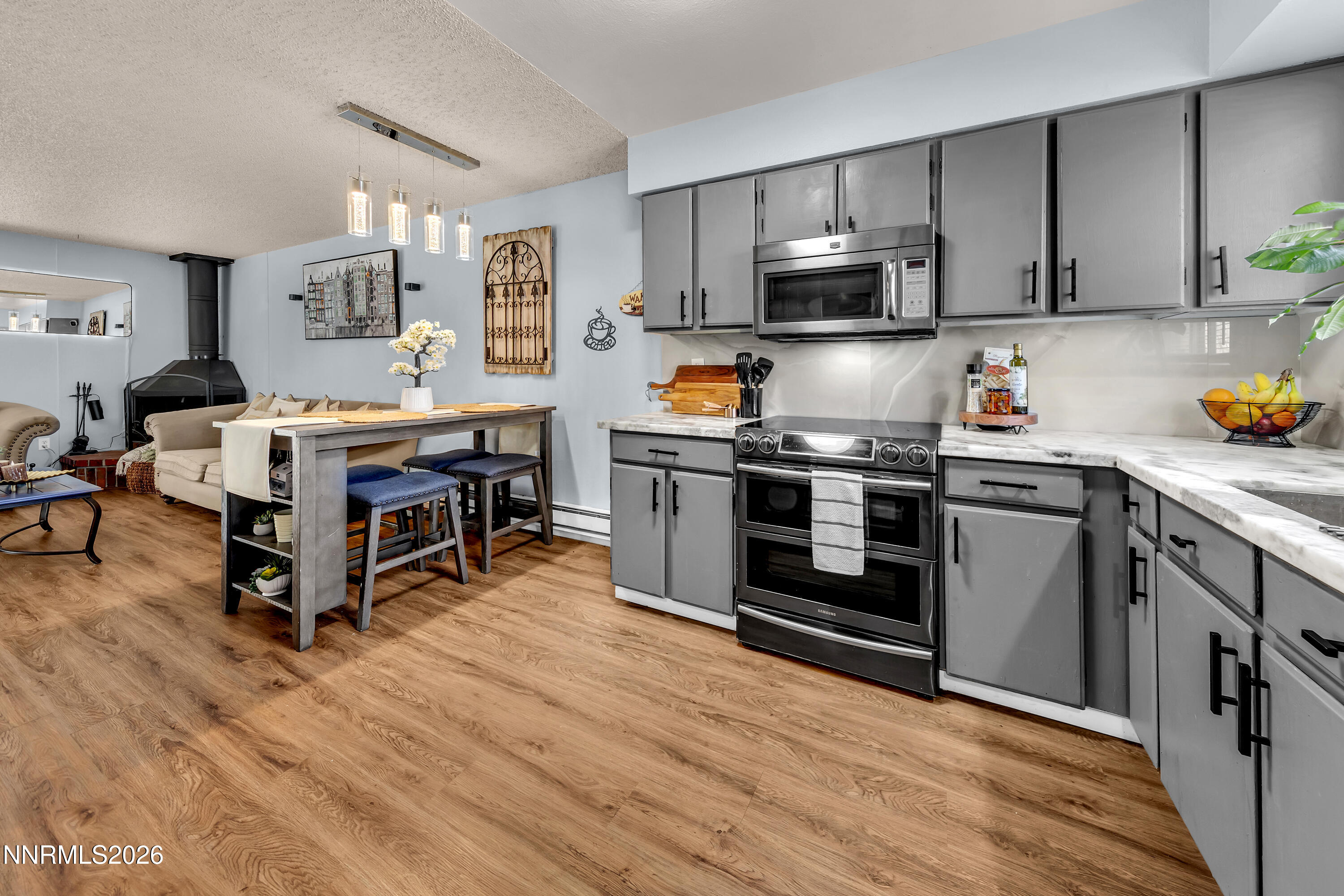 562 Smithridge Park Reno, NV 89502 - Photo 8 of 43 a kitchen with stainless steel appliances a stove cabinets and wooden floor