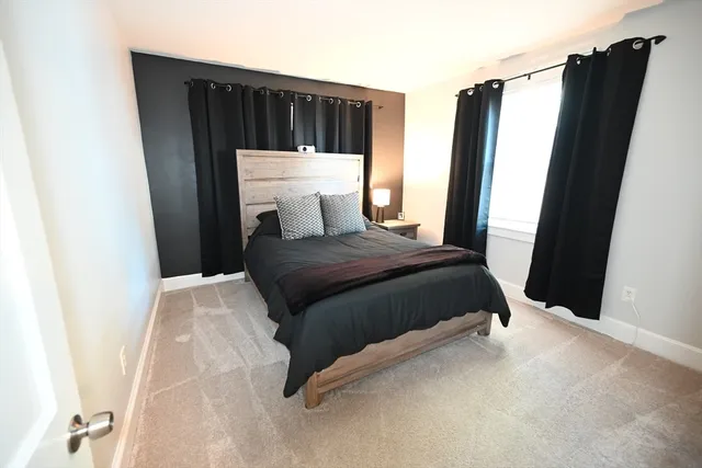 a bedroom with a bed and a mirror