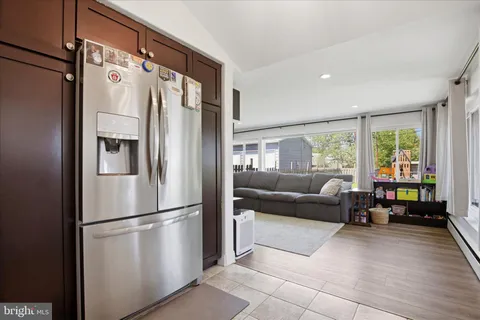 a living room with furniture window and refrigerator