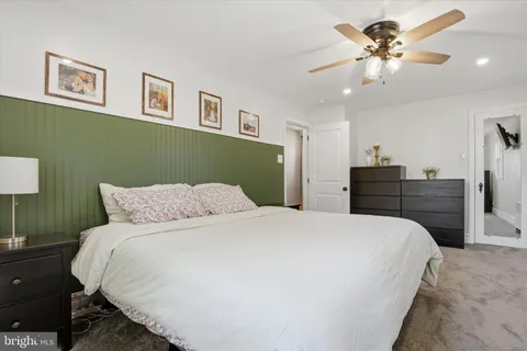 a spacious bedroom with a bed and a chandelier