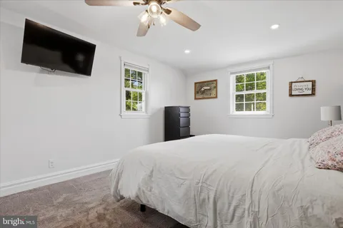a bedroom with a large bed and a flat screen tv