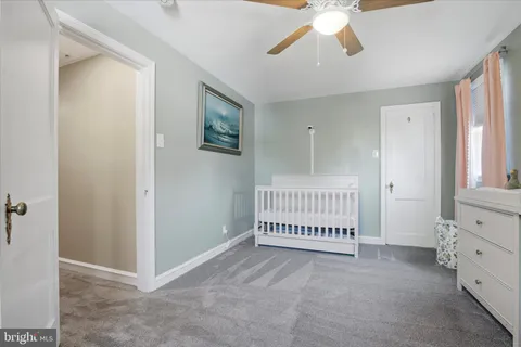 a view of an empty room with window and stairs