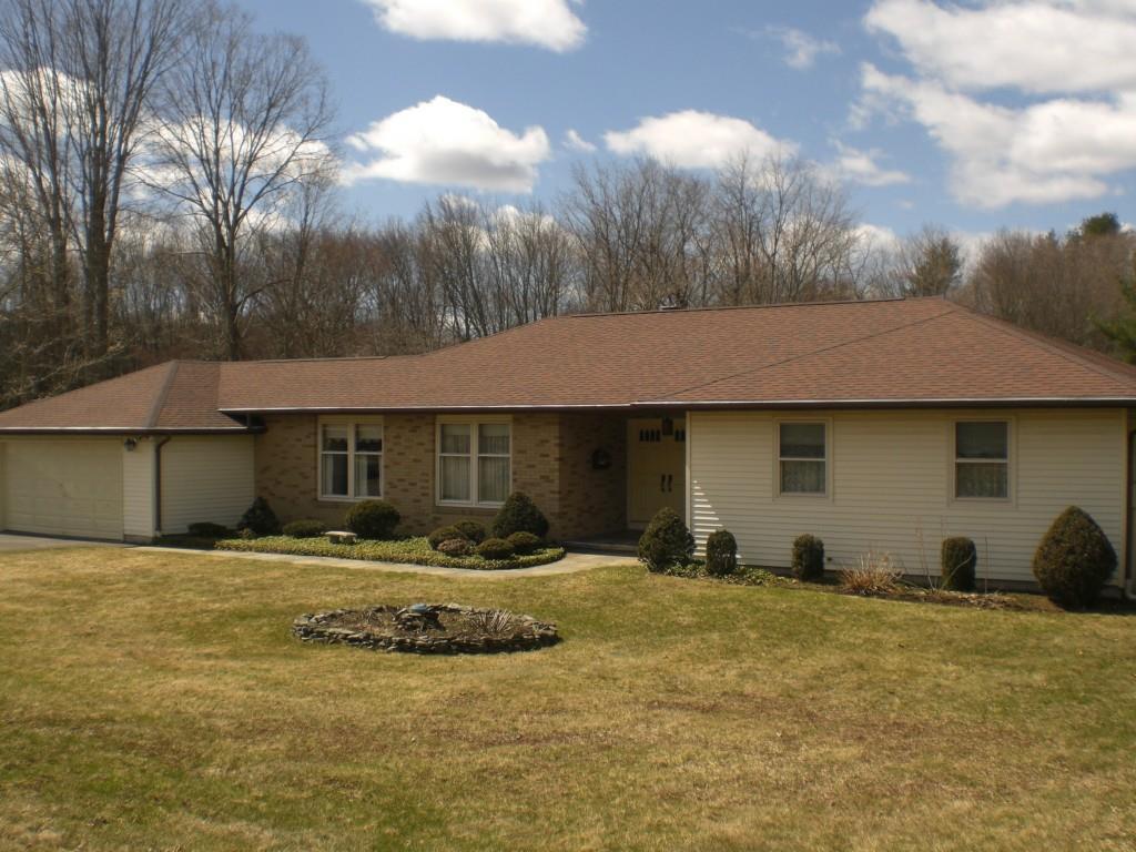 a view of a house with swimming pool and sitting area