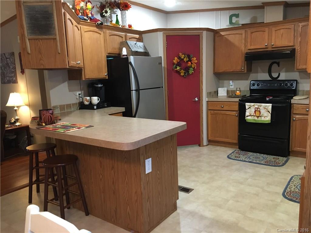 5125 Cabal Road Sharon, SC 29742 - Photo 13 of 21 a kitchen with stainless steel appliances kitchen island granite countertop a refrigerator a stove a sink and a stove