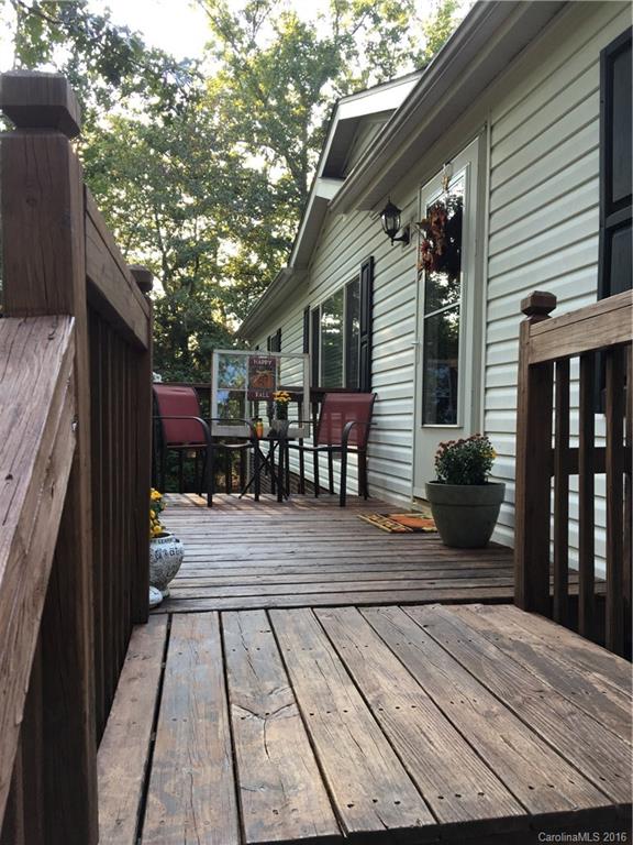 5125 Cabal Road Sharon, SC 29742 - Photo 8 of 21 a view of a patio with dining table and chairs with wooden floor and fence